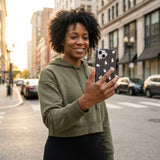 Black Ghost Stamps iPhone 14 Case - Lifestyle photo showing phone case in use