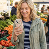 Seashell Tulip Bliss iPhone 14 Case - Lifestyle photo showing phone case in use