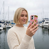 Bubblegum Pink Pickle Party iPhone 15 Case - Lifestyle photo showing phone case in use