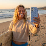 Powder Blue Ocean Charms iPhone 16 Pro Case - Lifestyle photo showing phone case in use