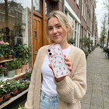 Clear Little Cherries iPhone 17 Case With Petal Pink Ridge (MagSafe included) - Lifestyle photo showing phone case in use