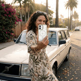 Clear Vanilla Flora iPhone 17 Pro Case With London Fog Ridge (MagSafe included) - Lifestyle photo showing phone case in use