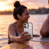 Clear Tulip Dreams iPhone 17 Case With Noir Ridge (MagSafe included) - Lifestyle photo showing phone case in use