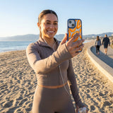 Clear Juicy Papayas iPhone 17 Pro Case With True Blue Ridge (MagSafe included) - Lifestyle photo showing phone case in use