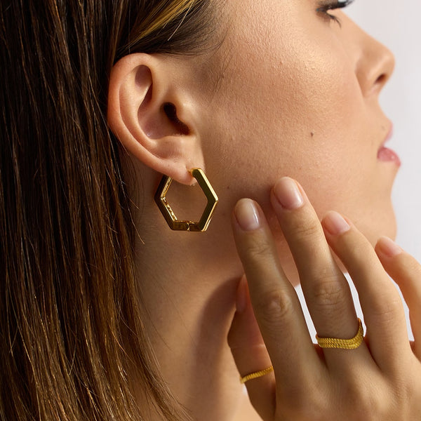 Rise and shine! Everyday styling just got easier with these head-turning hexagonal gold hoops.  The hexagonal hoop earrings are the most geometric shape of the Bella collection, ideal for the modern woman wanting something simple yet stylish to we