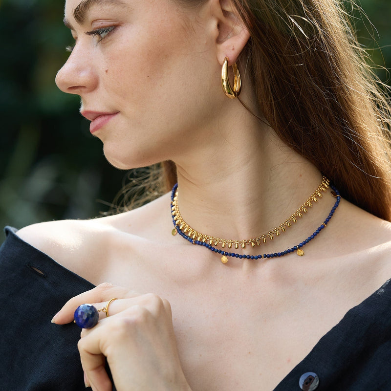 The Bubble Lapis Lazuli Ring features a deep celestial blue gemstone with gold chips, attached to a size adjustable 14 Carat gold vermeil ring. This allows the gemstone to move freely around your finger making this a unique ring. 