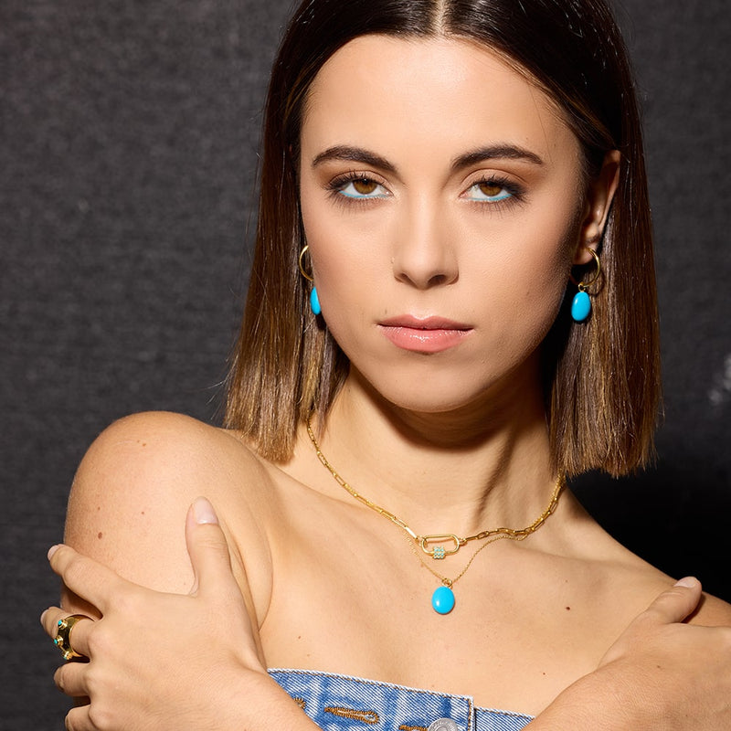 The Daphne Gold Paperclip Link Chain Necklace with Turquoise Carabiner lock will add a touch of colour to your wardrobe and make you feel like the warmer months are here to stay!