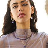 Our Eden Gold Hoop Earrings are handmade in various sizes and are bejewelled with a removable Amethyst gemstone charm. Match them with our Eden necklaces for a complete look!