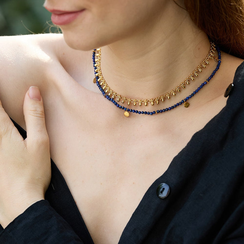 If you love a pop of colour but tend to be on the effortless side, our Eva Lapis Lazuli Necklace with gold discs is perfect for you. Entirely handmade with recycled tiny faceted Lapis Lazuli beads, the necklace is fully size adjustable and is reversible with a contrasting embossed effect on one side of the gold disc and plain smooth on th