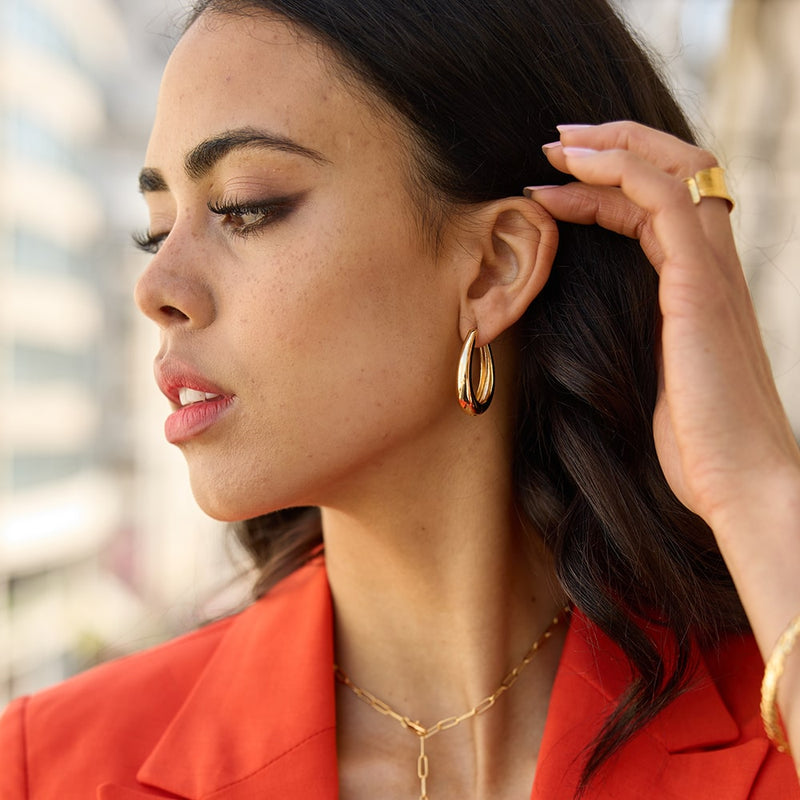 You can't go wrong with a pair of Lola Large Curve Hoop Earrings. Super lightweight and comfortable, you'll hardly notice they're there (except when you receive compliments, of course).  The earrings are made of recycled materials including recycled brass dipped in several thick layers of recycled 14 Carat Gold.