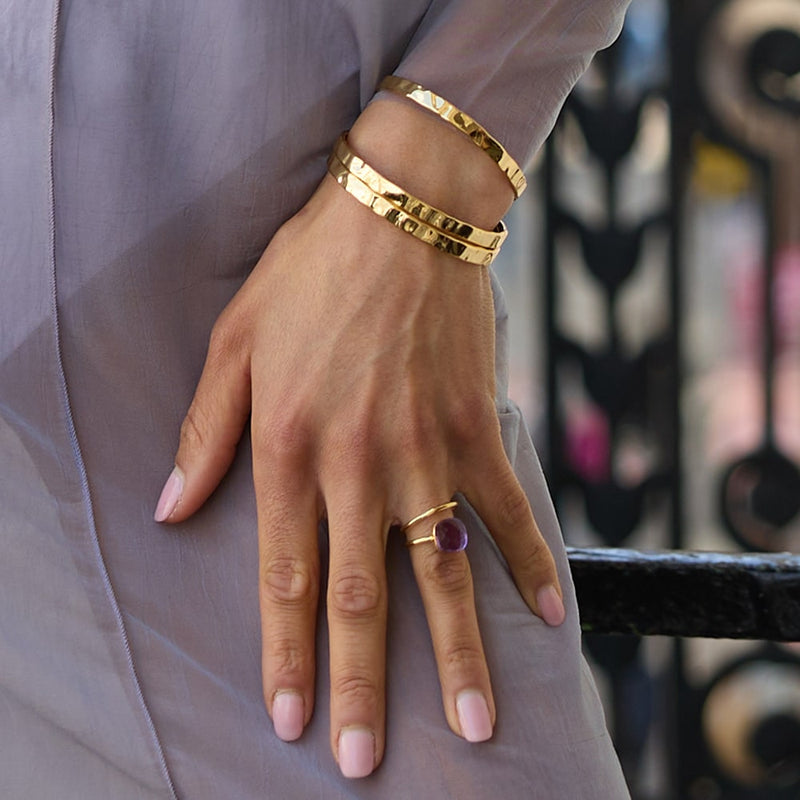 The Otto Hammered Gold Bangle  can simply be worn with a white t-shirt or used to bring a little bit of glam to an evening dress. Delicately handmade and hammered to give a suble texture, the bangle will fit any wrist size. Wear alone or stack up with multiple bracelets and bangles. 