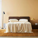 Elegant Butter-colored sateen sheets, crafted for a serene and luminous bedroom ambiance