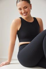 Model wearing black capri leggings