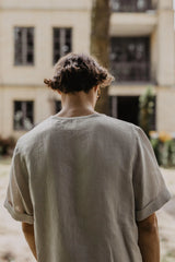 Back Shot Of Man Wearing A White Linen Top