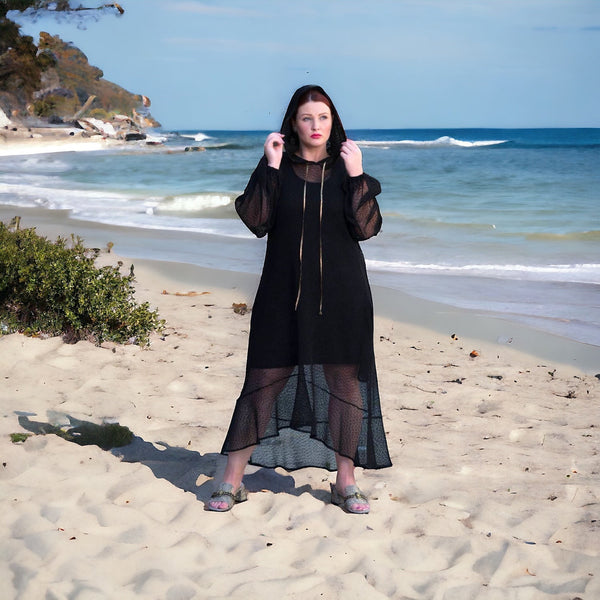 Plus Size Aphrodite Black Holiday Resort Dress with hoodie and black undergarment, styled with golden sandals for a chic and comfortable beach look.