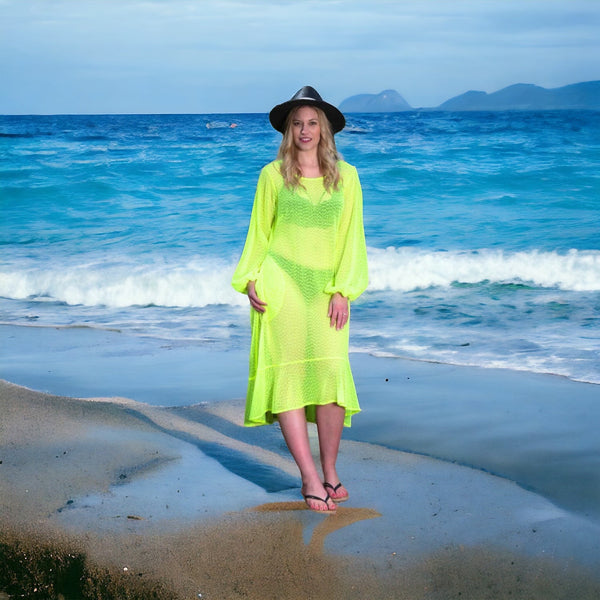 Women's Aphrodite Neon Lime Holiday Resort Dress styled with a bikini underneath, paired with a black hat and black flip-flops for a casual  beach look.