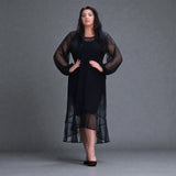 Women's Aphrodite Black Holiday Resort Dress with black undergarment, accessorized with black Ballerinas.