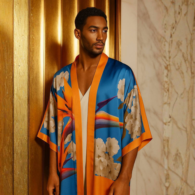 Man wearing a Colorful Bird of Paradise White Blue Cherry Blossom Silk kimono garment with abstract patterns against a neutral background