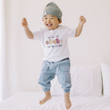 the wee bean cute kid jumping on bed in we are all human beans tee