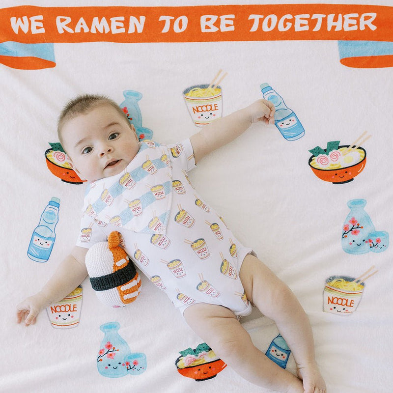 cute baby laying on the wee bean milestone blanket in ramen noodle