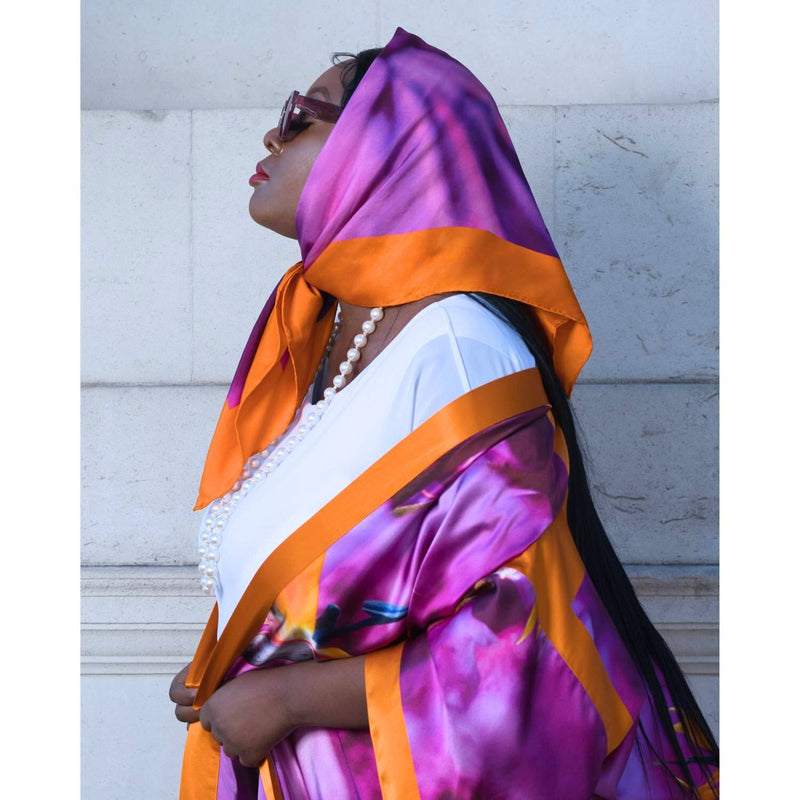 Silk scarf with Orange Bird of Paradise and Pink and Purple print styled as a headscarf, paired with Pink sunglasses and a Pink and Purple Luxury Silk Kimono.