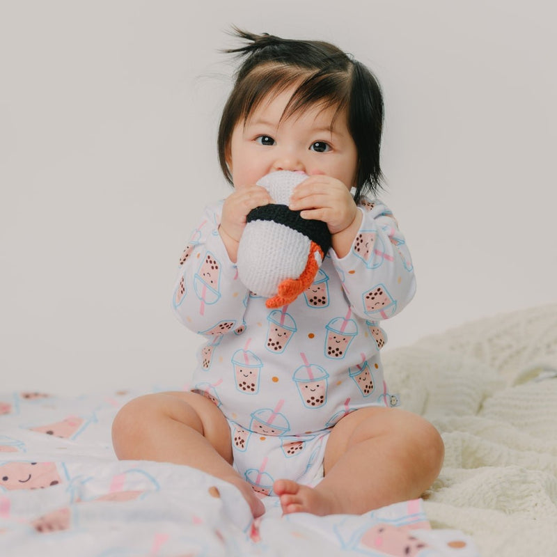 cute baby chewing on the wee bean sushi rattle doll