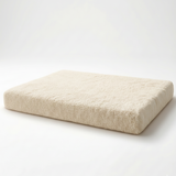 Beige foam mattress topper on a white background