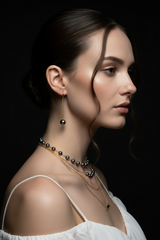 Model wearing Gold Stainless Steel Black Pearl Earrings - Black Background