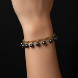 Woman wearing Black Pearl Charm Bracelet - no logo visible