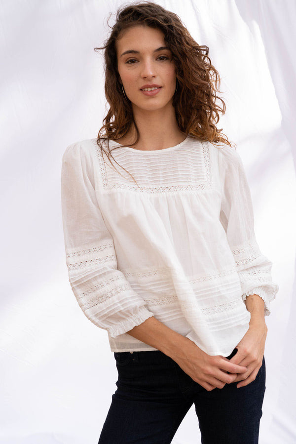 Dawn Blouse in cloud white color for women by Paneros Clothing. From soft cotton voile with pin tucks and lace trim. Front View.