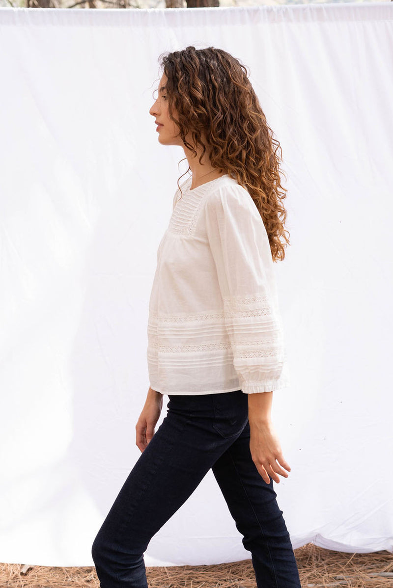 Dawn Blouse in cloud white color for women by Paneros Clothing. From soft cotton voile with pin tucks and lace trim. Side View.