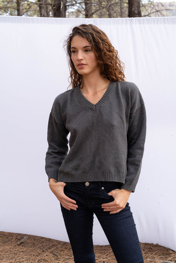 Jolene vee neck handknitted sweater in charcoal grey for women by Paneros Clothing. Featuring side slits, relaxed fit, and a v neckline from 100% cotton. Front Detail View.