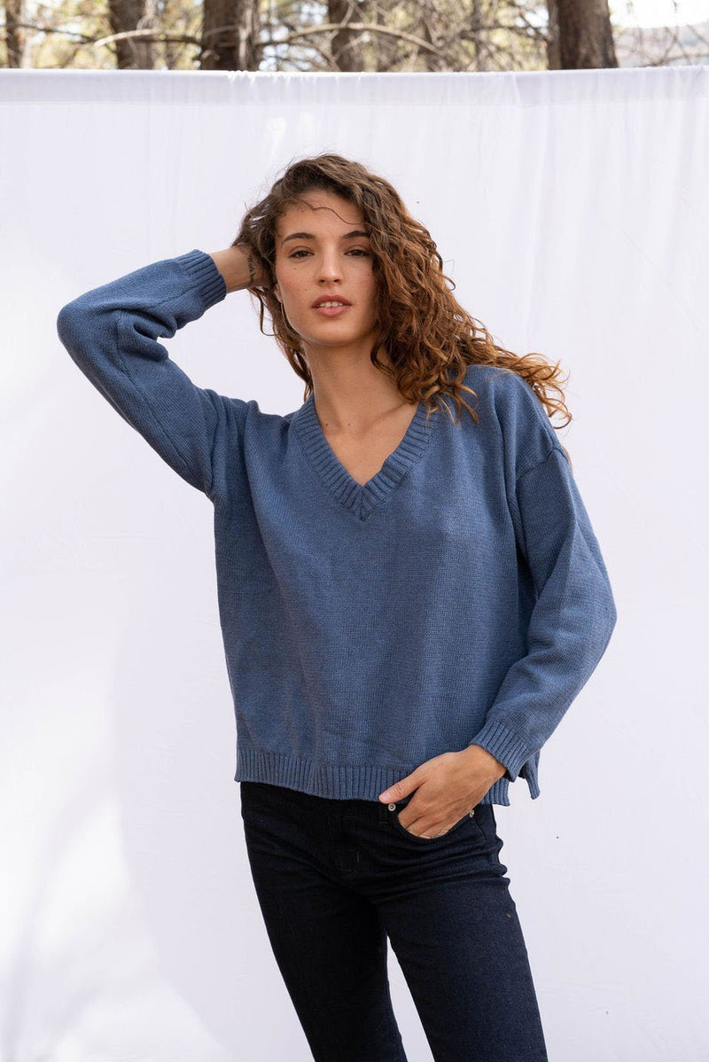 Jolene vee neck handknitted sweater in vintage navy blue for women by Paneros Clothing. Featuring side slits, relaxed fit, and a v neckline from 100% cotton. Front Detail View.