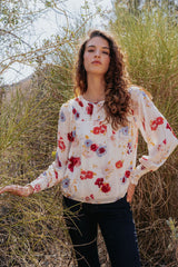 Mabel Blouse in Prairie Bloom print for women by Paneros Clothing. Made from 100% deadstock rayon fabric. Front View with styling.