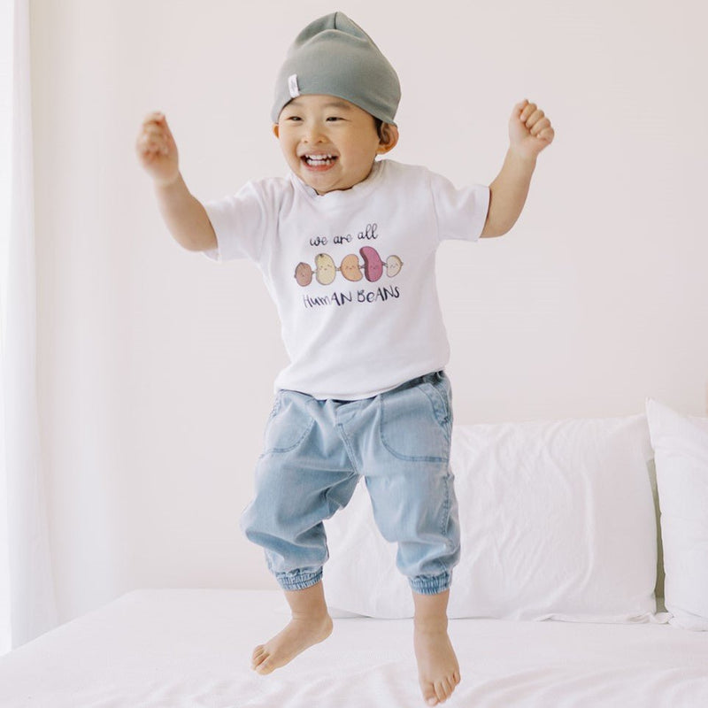 the wee bean cute kid jumping on bed in we are all human beans tee