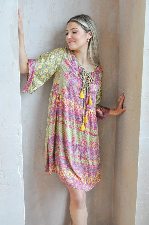 Bell sleeve yellow printed dress made of upcycled saris. loose fitting with tassels and a tie.