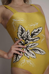 Detail on the floral print on yellow one piece swimsuit.